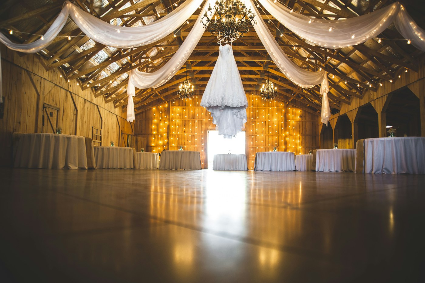 A barn wedding venue lit with fairy lights