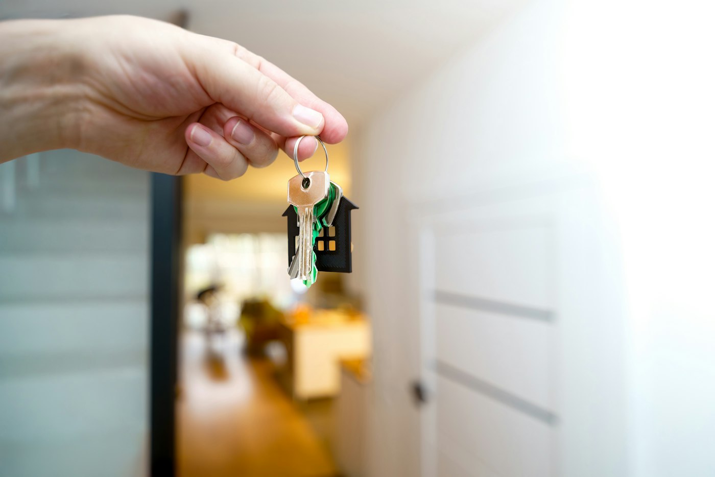 A hand holding a set of house keys
